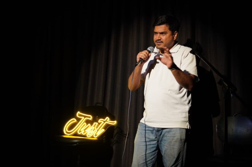 Abdullah Khan speaking on stage